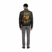 Men's leather jacket with Cobra Kai logo and 'Strike First, Strike Hard, No Mercy' text on back