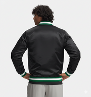 Black satin bomber jacket with green and white ribbed trim, worn by man with hands on hips