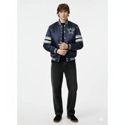 Navy blue varsity jacket with star logo and striped sleeves, paired with black jeans
