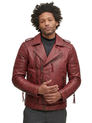 Man wearing burgundy leather biker jacket with quilted shoulders and zippers, styled over gray turtleneck
