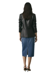 Black leather blazer with blue denim midi skirt and black heels, back view