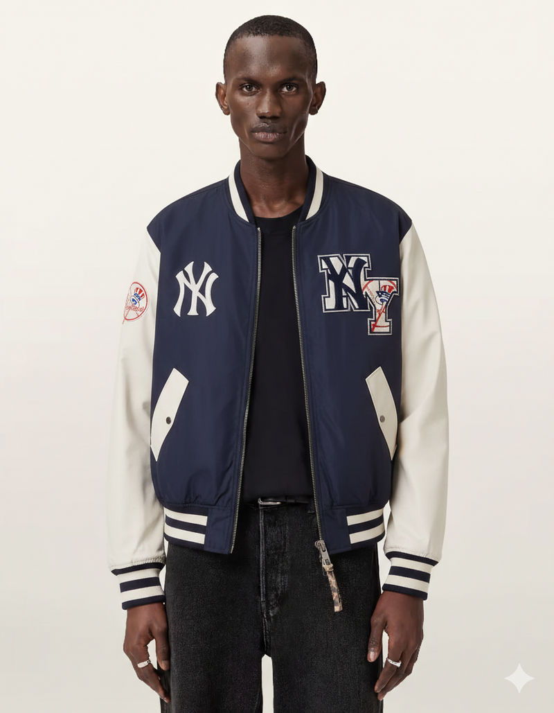 Men's navy and cream varsity jacket with NY Yankees logo, front zipper, and patch details