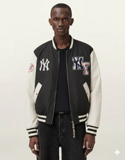 Black and white varsity jacket with NY logos, worn over black shirt and jeans