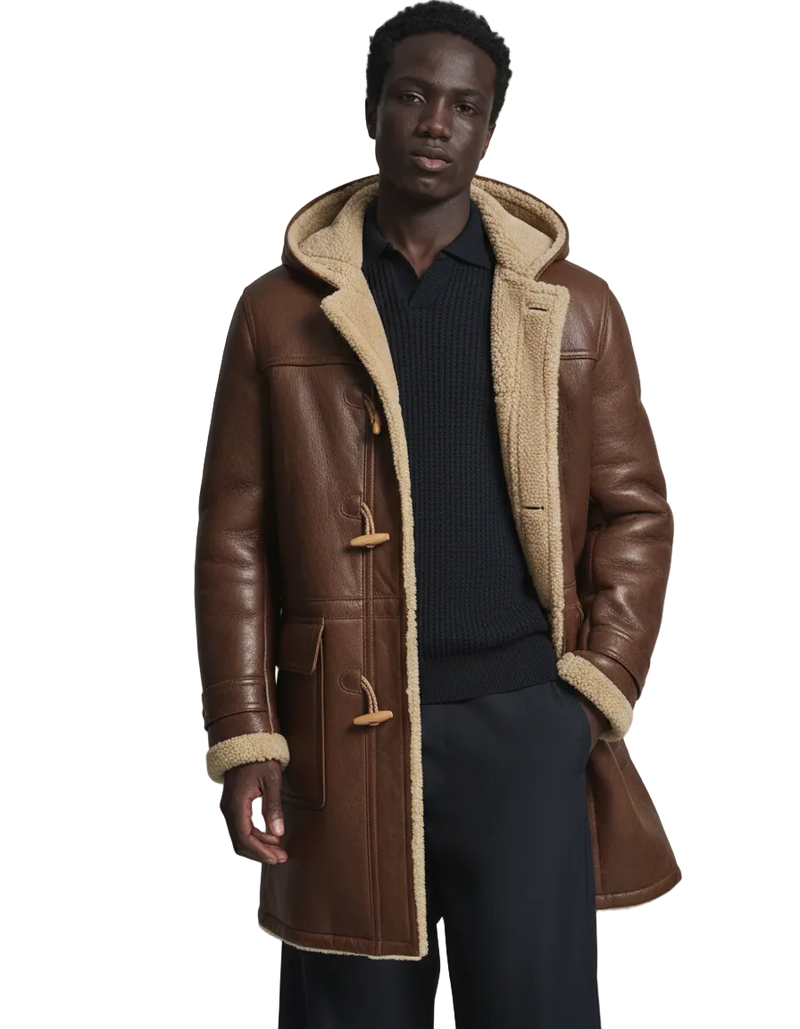 Man wearing a brown leather coat with beige fur lining on a gray background