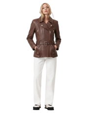 Brown leather moto jacket with belt, white pants, and sneakers for women's fashion
