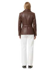 Brown leather jacket with belt back view, paired with white pants and sneakers