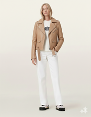 Tan leather moto jacket with belt, styled with white jeans and sneakers for casual chic look