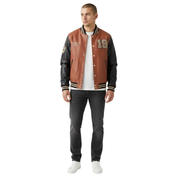 Men's brown and black varsity jacket with number 19, worn with white tee and dark jeans